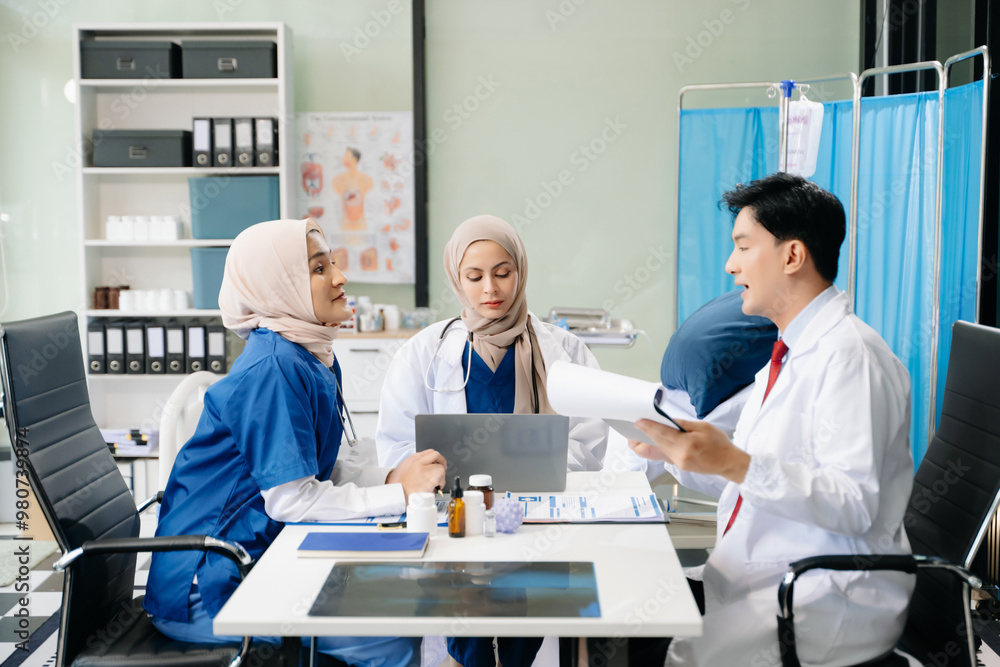 © Nuttapong punna - Doctors and nurses working together in a hospital ward, showcasing professionalism, teamwork