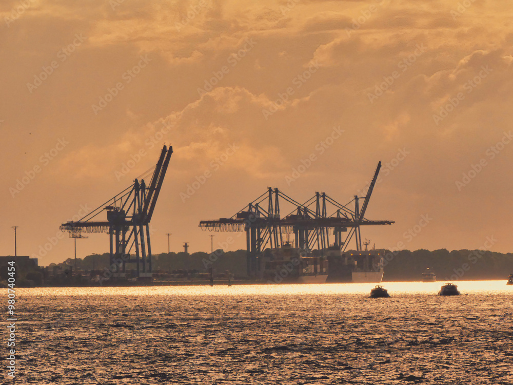 Cranes at sunset in the port of Hamburg Cranes at sunset in the port of Hamburg
