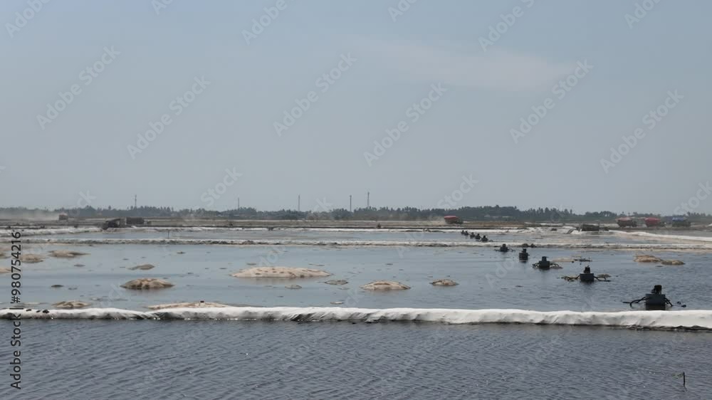 The reclamation project in the Pantai Indah Kapuk 2 - PIK 2 area, North Jakarta. A pump is used to drain seawater and trucks are transporting filling materials. The reclamation project in the Pantai Indah Kapuk 2 - PIK 2 area, North Jakarta. A pump is used to drain seawater and trucks are transporting filling materials.