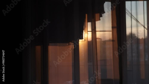 Transparent tulle at sunset close up, clothes hanging and drying on the balcony. Cozy home background
