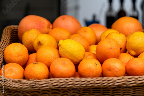 Obraz na płótnie A basket of oranges, tangerines and lemons at the market in closeup w salonie