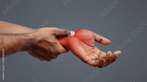 Obraz na plátne Carpal tunnel pain. Black guy massaging painful wrist, close up