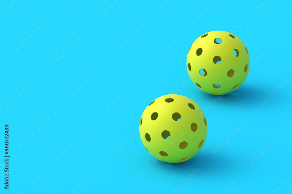 Two pickleball balls on blue background. Sports equipment. Hobby and leisure games. Copy space. 3d render Two pickleball balls on blue background. Sports equipment. Hobby and leisure games. Copy space. 3d render