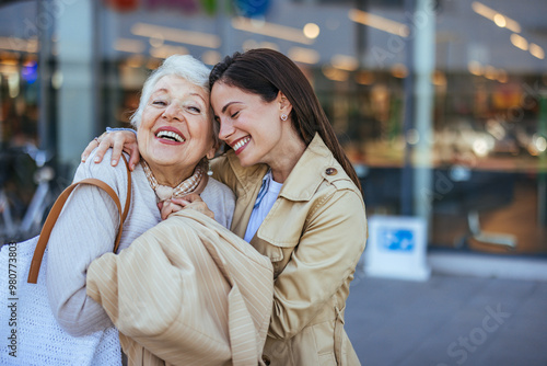Happy Grandmother and Granddaughter Embracing Outdoors in City