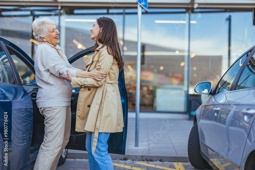 Fotografie Joyful Reunion Between Women in Parking Lot