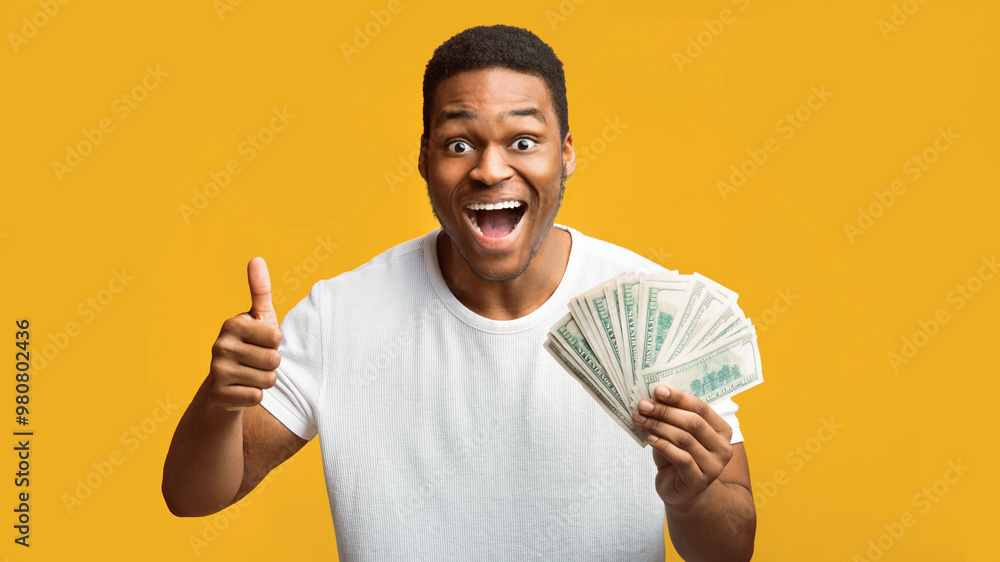 Easy Money, Jackpot, Unexpected Income. Excited african american man holding bunch of money and showing thumb up Easy Money, Jackpot, Unexpected Income. Excited african american man holding bunch of money and showing thumb up