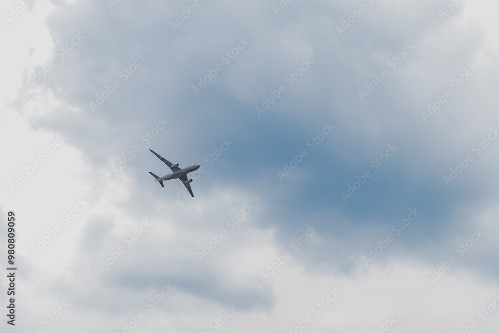 Airplane in the sky: An airplane in flight is captured against a slightly cloudy sky. The shot highlights the power of the aircraft and the vastness of the sky. Airplane in the sky: An airplane in flight is captured against a slightly cloudy sky. The shot highlights the power of the aircraft and the vastness of the sky.