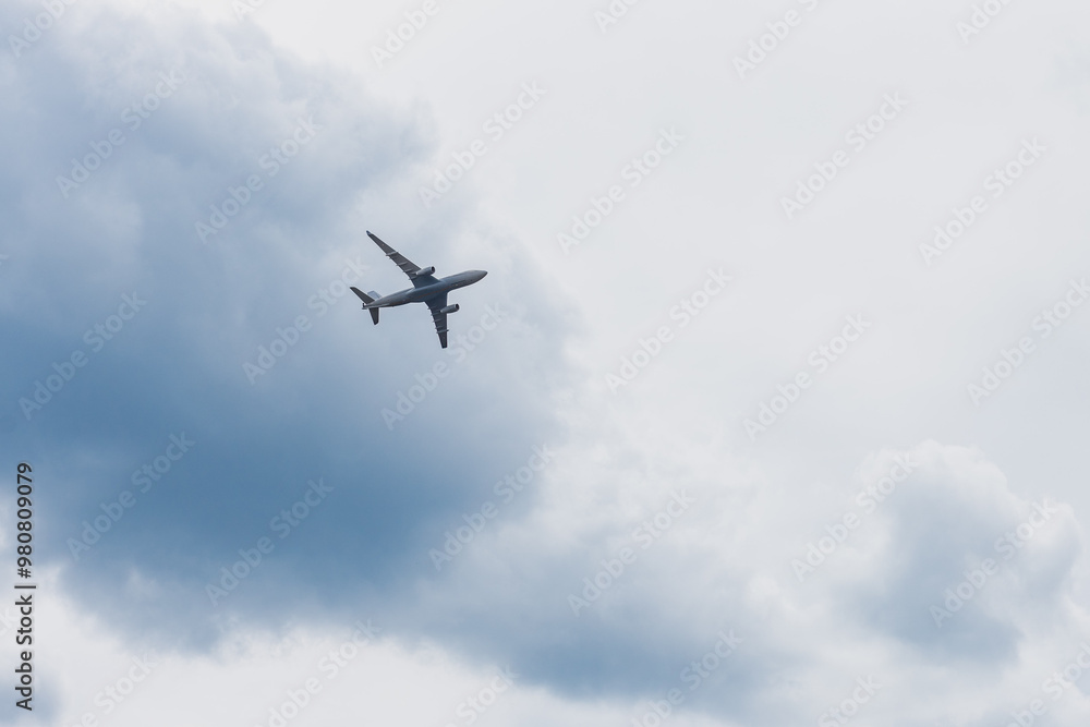 Airplane in the sky: An airplane in flight is captured against a slightly cloudy sky. The shot highlights the power of the aircraft and the vastness of the sky. Airplane in the sky: An airplane in flight is captured against a slightly cloudy sky. The shot highlights the power of the aircraft and the vastness of the sky.
