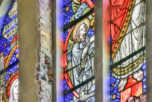 Colorful stained glass window with angelic depiction