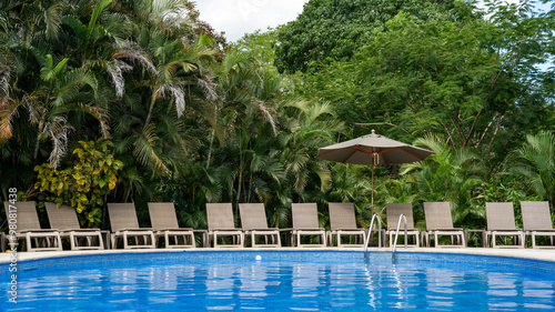 Serene tropical poolside with sun loungers, Costa Rica photo