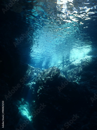 sun rays sun beams and sun shine underwater in cave beautiful light scenery in ocean scuba divers to see in cave backgrounds