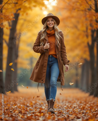 Smiling woman walking in an Autumn forest with Colorful Fall Leaves. Full body shot on bokeh background