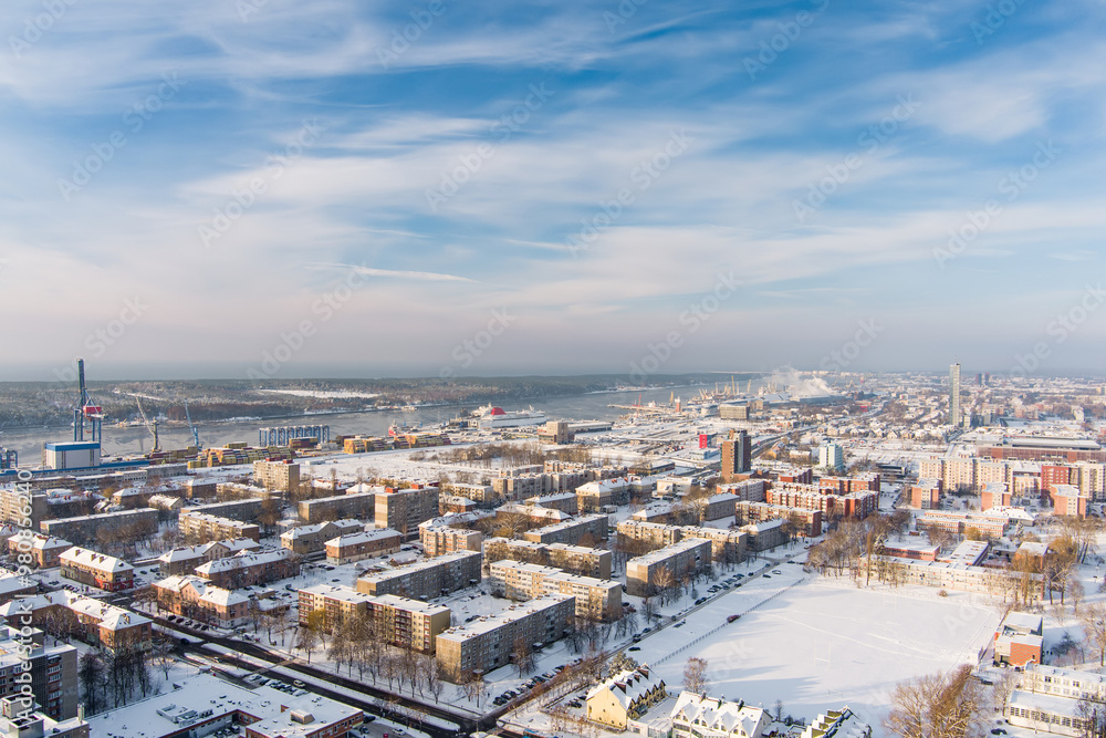 Fototapeta premium Aerial view of Klaipeda city port area and it's surroundings on sunny winter evening. The Old town of Klaipeda, Lithuania in evening light at wintertime.