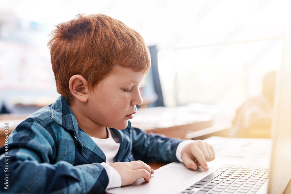 Laptop, search and boy in classroom for lesson in growth, child development and technology for education. Desk, learning and students with website for knowledge, typing and study at elementary school Laptop, search and boy in classroom for lesson in growth, child development and technology for education. Desk, learning and students with website for knowledge, typing and study at elementary school