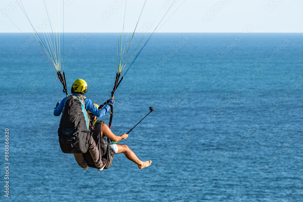 Paragliding in Phuket Thailand with blue sky. Men paragliding high up in the sky with beautiful landscape. Paragliding in Phuket Thailand with blue sky. Men paragliding high up in the sky with beautiful landscape.