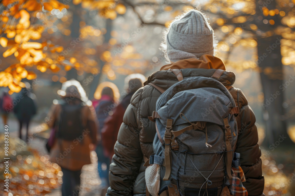 Group of People Hiking in Forest During Autumn with Backpacks and Warm Jackets Group of People Hiking in Forest During Autumn with Backpacks and Warm Jackets
