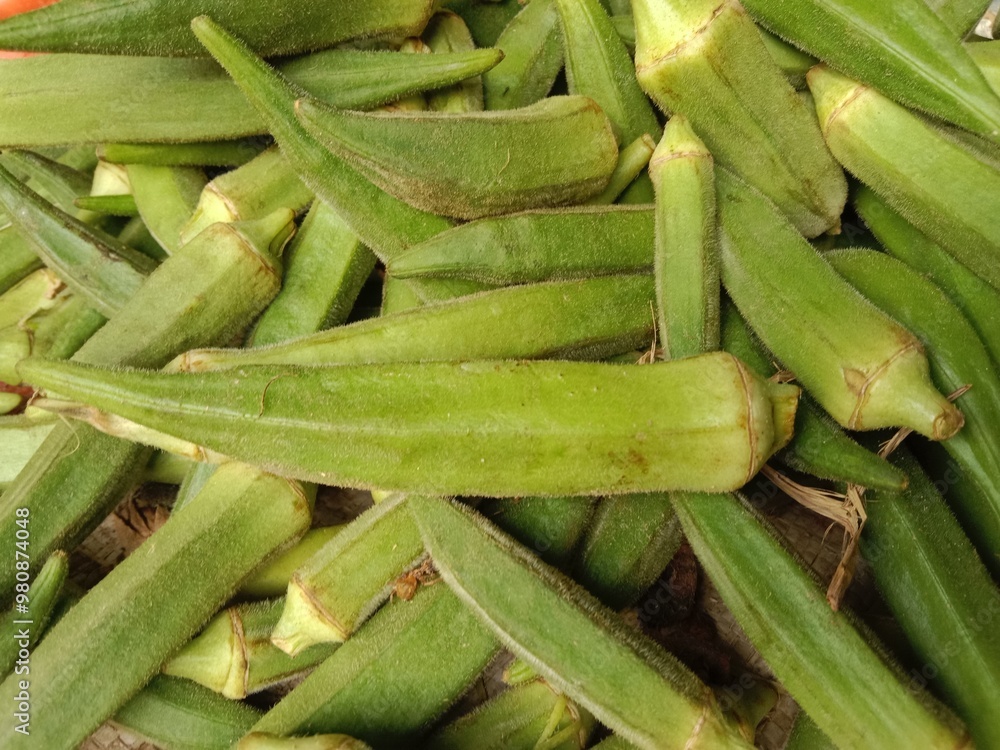 lady finger pile displayed in order on vendor's.okra pile show for sale in the market.Abelmoschus esculentus pattern background lady finger pile displayed in order on vendor's.okra pile show for sale in the market.Abelmoschus esculentus pattern background