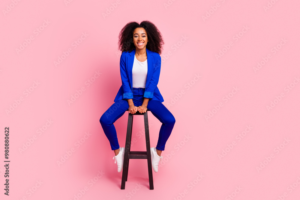 Photo of adorable lovely girl wear trendy blue clothes sit wooden stool isolated on pink color background Photo of adorable lovely girl wear trendy blue clothes sit wooden stool isolated on pink color background
