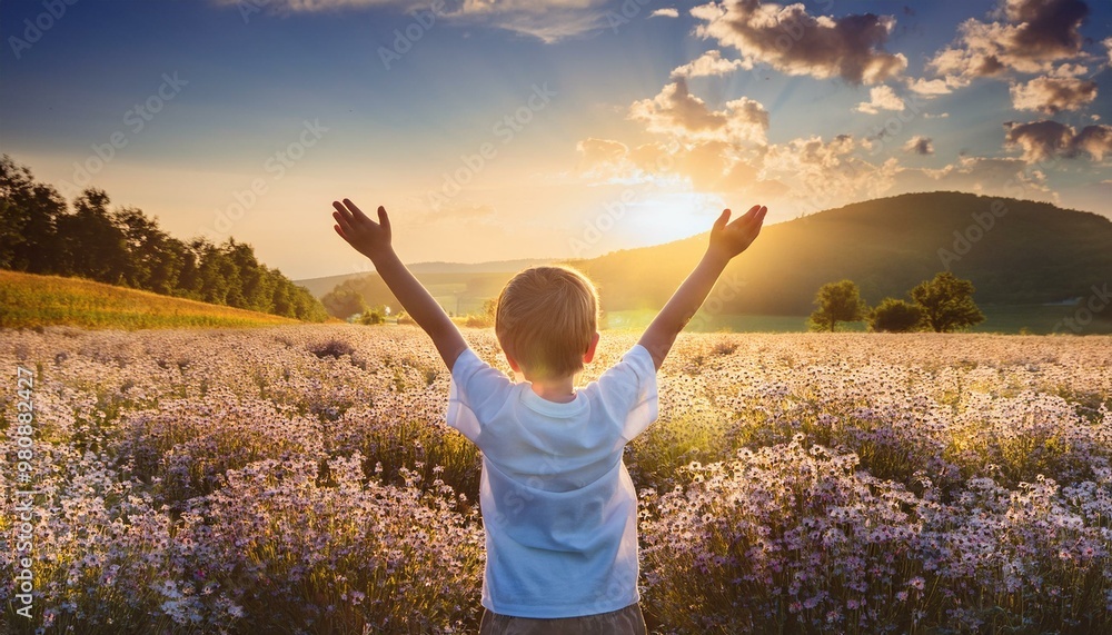 Boy is Praying to God on the Field full of Flowers with some sun and blue sky. Boy is Praying to God on the Field full of Flowers with some sun and blue sky.