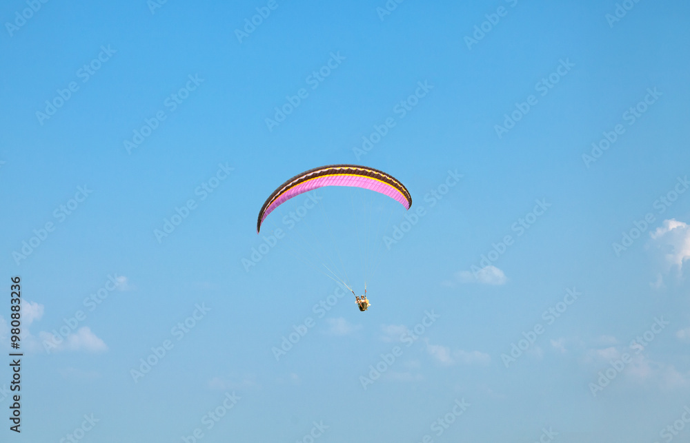 Paragliding. A paraglider flies in the air on a paraglider. Paragliding. A paraglider flies in the air on a paraglider.