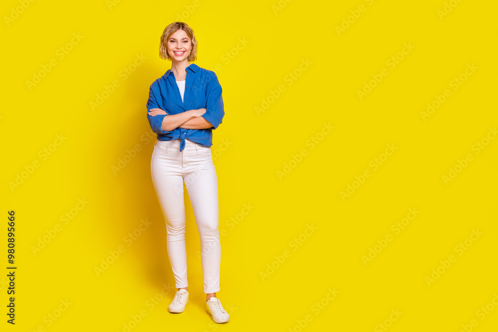 Full body portrait of pretty young lady folded arms empty space wear shirt isolated on yellow color background Full body portrait of pretty young lady folded arms empty space wear shirt isolated on yellow color background