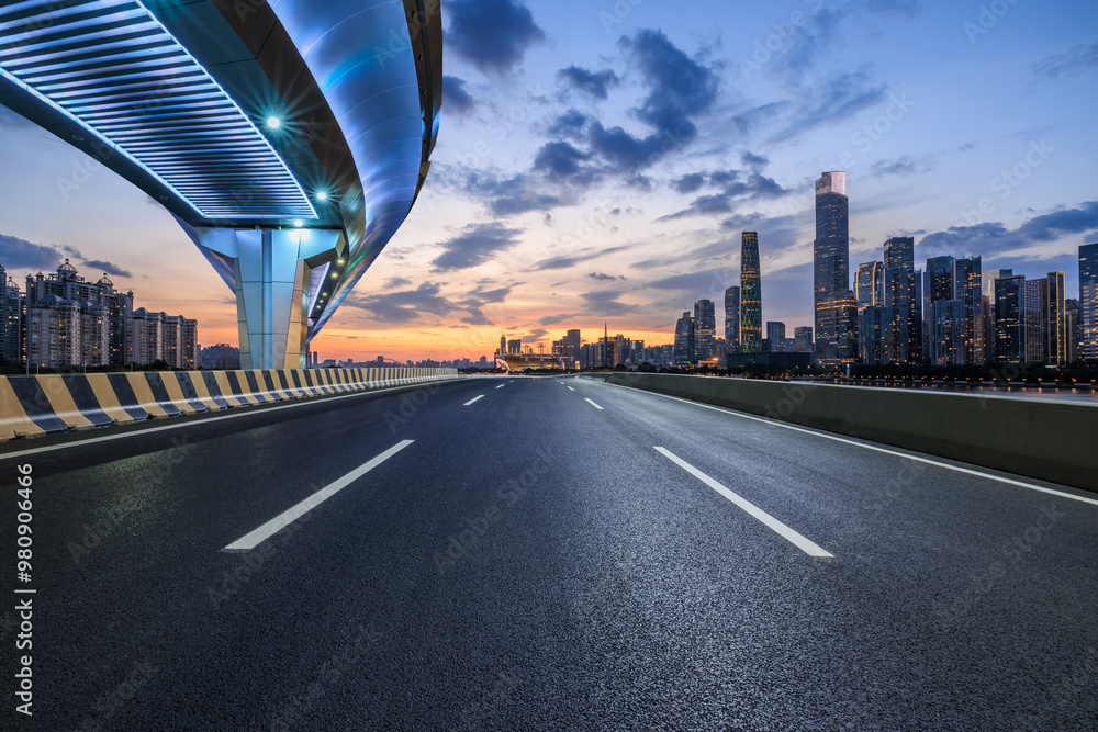Asphalt highway road and bridge with modern city buildings at night in Guangzhou. car advertising background.