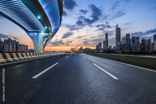 Obraz na płótnie Asphalt highway road and bridge with modern city buildings at night in Guangzhou. car advertising background. w salonie