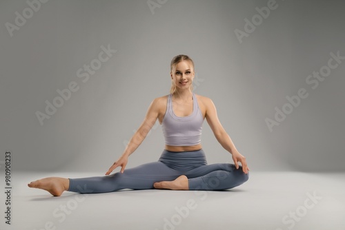 Young woman practicing yoga in a spacious, well-lit studio during morning