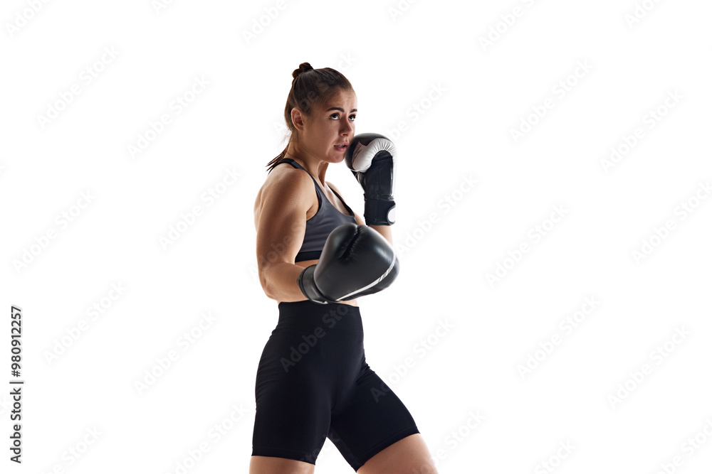 Concentrated young woman in boxing gloves, practicing, growing skills and attention during fight isolated on white studio background. Concept of sport, hobby, active and healthy lifestyle Concentrated young woman in boxing gloves, practicing, growing skills and attention during fight isolated on white studio background. Concept of sport, hobby, active and healthy lifestyle