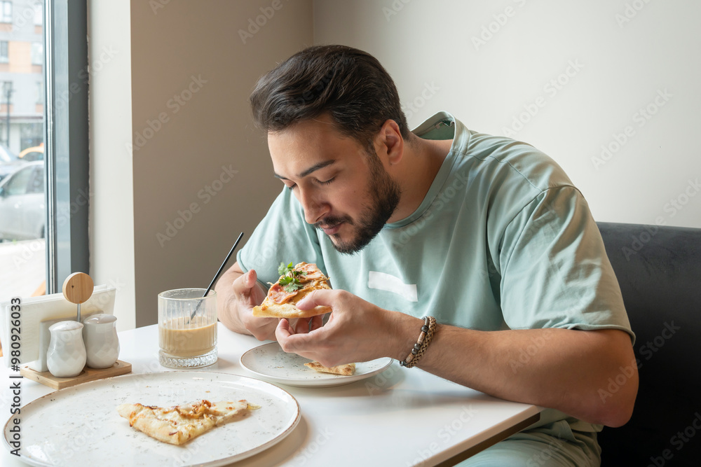 Hungry man eats delicious pizza at the cafe Hungry man eats delicious pizza at the cafe