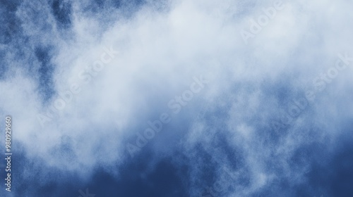 A fluffy white cloud drifting across a clear blue sky during a bright afternoon in a tranquil setting