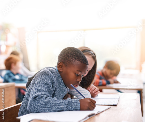Fotografie Desk, writing and kids in classroom for education in growth, child development and notebook for math test