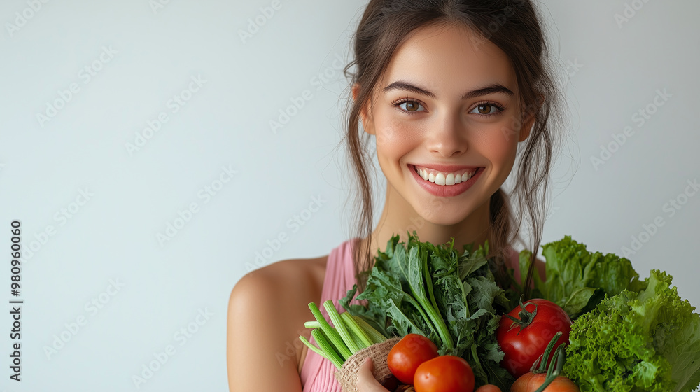 A smiling young woman holds a variety of fresh vegetables and greens, promoting healthy eating and a vibrant lifestyle. A smiling young woman holds a variety of fresh vegetables and greens, promoting healthy eating and a vibrant lifestyle.