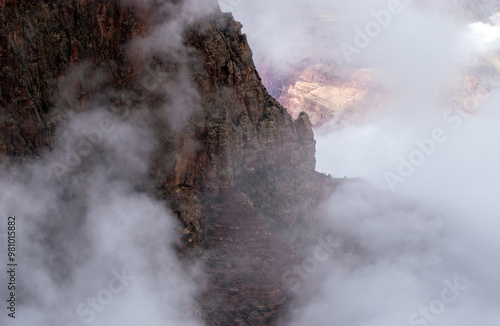 White fog moving around mountain formation