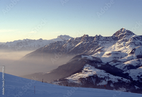 Majestic Snow-Capped Mountains Under Glowing Sunrise