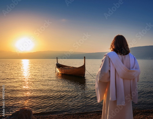 Jesus Christ overlooking  the Sea of Galilee at sunrise with a wooden boat from the bible period in background