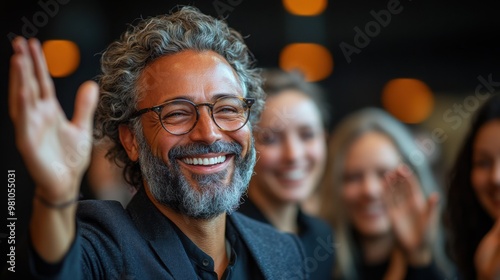 Smiling and Waving: A charismatic middle-aged man with a warm smile and a welcoming wave, radiating positivity and approachability in a professional setting. He embodies genuine connection and engagem photo