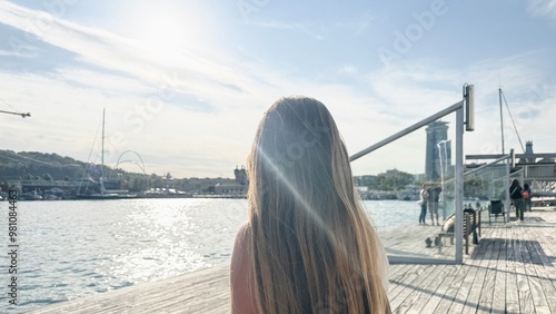 Woman tourist in summer sitting on her back in the port of Barcelona. photo