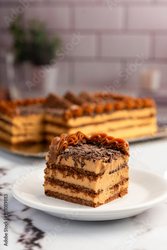 sweet dessert choco cake with chocolate cookies dulce de leche cream cheese on kitchen counter decorated with broken chocolate