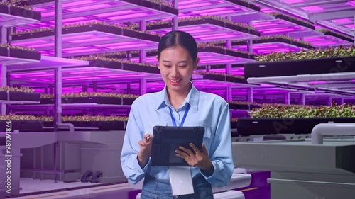 Wallpaper Mural Asian Female Professional Worker Standing With Her Tablet In Vertical Farm, High-tech Industrial Facility, Work Continuously With Her Tablet Torontodigital.ca
