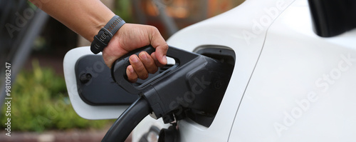 Electric car charging station. Hybrid car Electric charger station in the Car Park. Electric car charging on parking and charging station. Electric socket. Transportation EV.