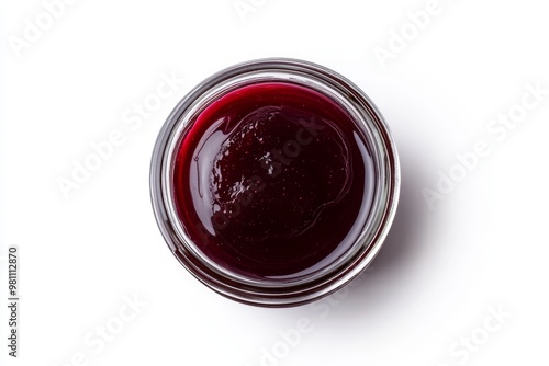 a delicate glass jar filled with creamy manjar, topped with a rich plum syrup, isolated on a white background, viewed from directly above