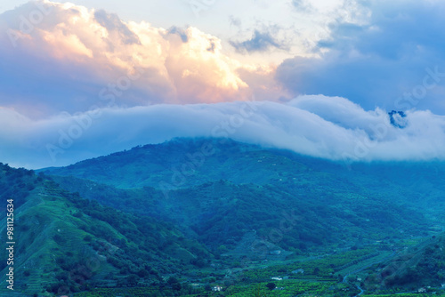 sceniv view an amazing twinlight mountain among beautiful evening sunset clouds, nature landscape photo