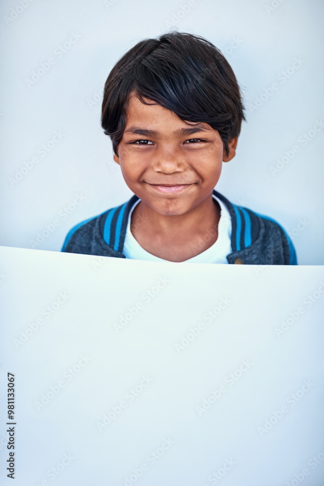 Boy, portrait and blank board in studio, student and news bulletin on education or white background. Male person, mockup space and public message on cardboard for advertisement, placard and India Boy, portrait and blank board in studio, student and news bulletin on education or white background. Male person, mockup space and public message on cardboard for advertisement, placard and India