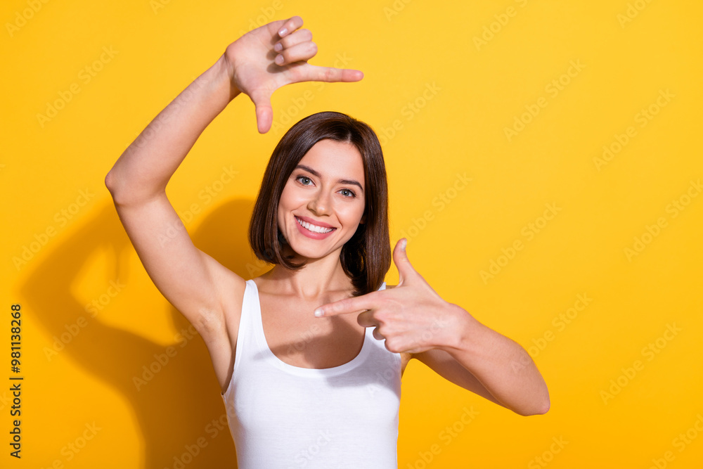 Photo portrait of attractive young girl fingers show frame gesture wear trendy white outfit isolated on yellow color background Photo portrait of attractive young girl fingers show frame gesture wear trendy white outfit isolated on yellow color background