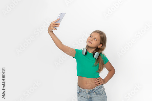 teen girl doing selfie in studio, isolated white background.