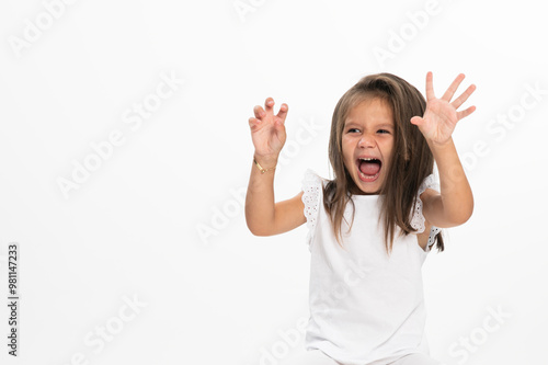 Little girl screaming in white clothes, over white background. Copy space, photo