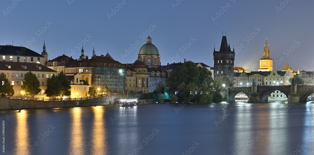 Naklejka premium Panoramic night view of the iconic Charles Bridge over Vltava river and Prague Old town cityscape, in Prague, Czech Republic