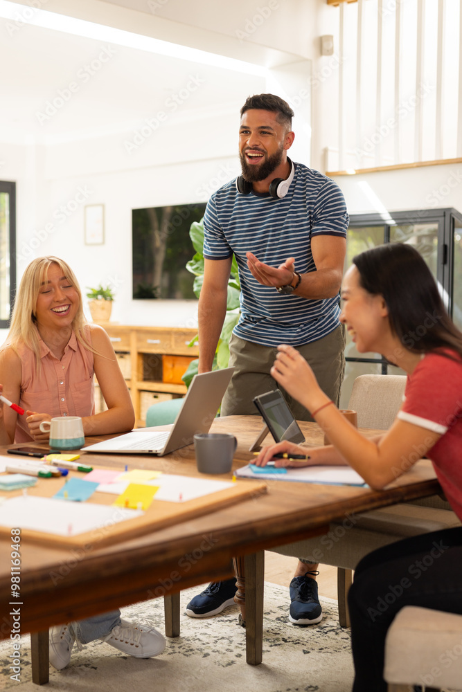 Start up business, collaborating on project, friends using laptop and tablet, brainstorming ideas Start up business, collaborating on project, friends using laptop and tablet, brainstorming ideas