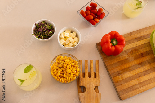 Preparing fresh salad with vegetables and tofu, ingredients on kitchen counter